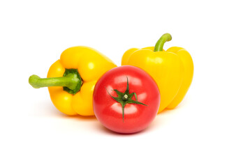 Fresh vegetables, whole red tomato and yellow bell pepper (paprika) isolated on white background