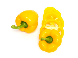 Whole and sliced yellow bell pepper or paprika isolated on white background