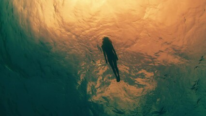 Young woman snorkeling and swimming in the sea in the Maldives