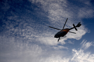 Naklejka na ściany i meble silhouette of helicopter flying in the sky