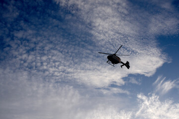 Fototapeta na wymiar silhouette of helicopter flying in the sky