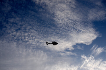 silhouette of helicopter flying in the sky