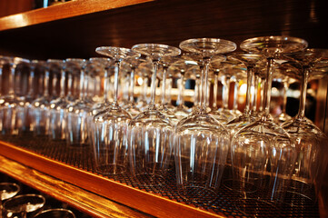 Glasses of wine upside down at bar counter.