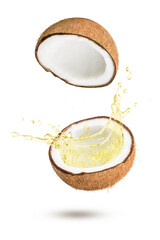 Coconut oil splash from half coco nut fruit  levitate in the air isolated on white background.