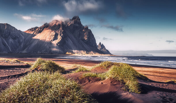 Scenic image of famous Stokksnes cape and Vestrahorn Mountain with  colorful dramatic sky during sunset in Iceland. Iconic location for landscape photographers. Amazing nature of World.