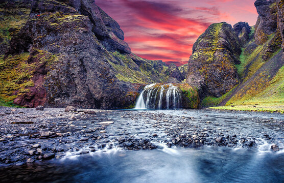 Fantastic Evening landscape with waterfall during sunset. Amazing Icelandic seascape. popular tourist attraction. Best famouse travel locations. Image of wild nature. Tipical Icelandic countryscape