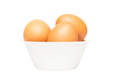 Cutout pile of brown organic egg in a biodegradable paper bowl on white background.