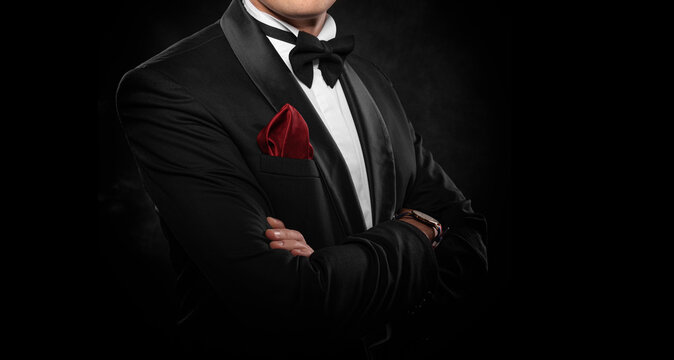 Element of the image of a man dressed in a tuxedo on a dark background.
