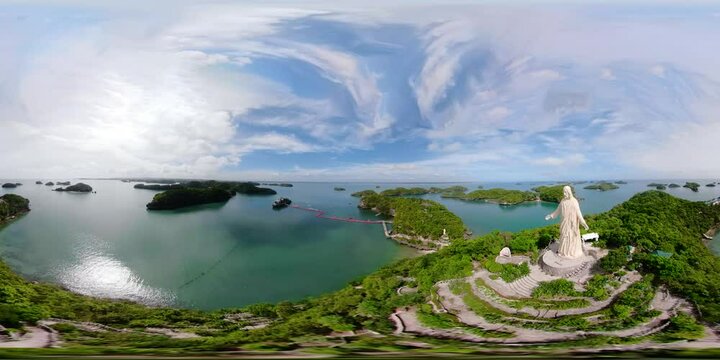 Statue of Jesus Christ on Pilgrimage island in Hundred Islands National Park, Pangasinan, Philippines. VR 360. Aerial view of group of small islands with beaches and lagoons, famous tourist attraction