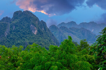 Vang Vieng Laos a beautiful city on the river with huge rising mountains and slow flowing river. 