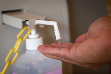 A hand alcohol dispenser at the entrance of public buildings in Japan.