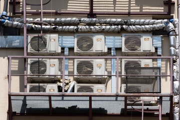 Lots of air conditioner (HVAC) on a housing building creating urban mess