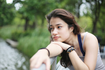 Naklejka premium Young attractive woman portrait at outdoor.