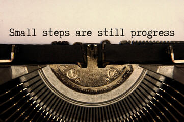 Small steps are still progress text typed on an old vintage typewriter in black and white