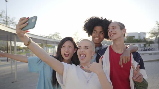 Multiracial group of people taking a selfie. Happy students together in a city center.