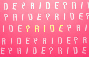 sign with white letters on a pink background with the message PRIDE
