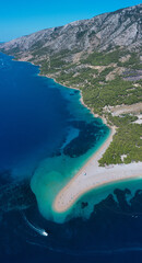 Zlatni Rat beach in Croatia - famous tourist vacation resort with sandy beach and crystal clear water.