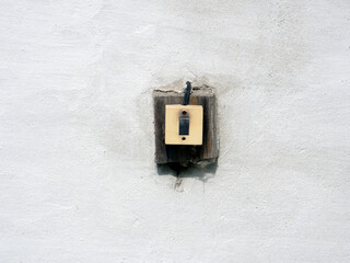 old switch for lighting are attached to the wall