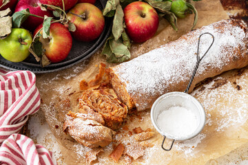Homemade traditional Apple strudel on a wooden background