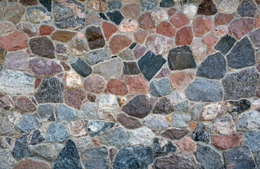 Stone wall with different colors and size of rocks