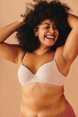 Cheerful plus size woman smiling happily in underwear - obrazy, fototapety, plakaty