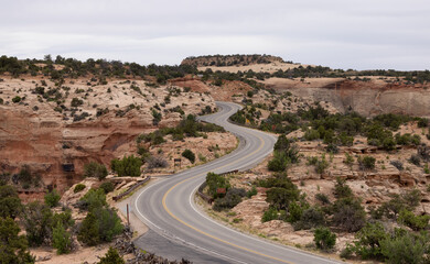 Fototapeta na wymiar Scenic Road surrounded by Red Rock Mountains in the Desert. Spring Season. Canyonlands National Park. Utah, United States. Adventure Travel.