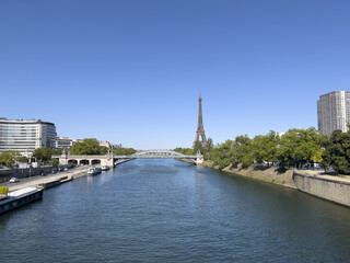 Obraz premium Blues and greens of Paris Summer, Green trees along the River Seine, Pure Blue Sky.