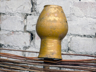 Clay jugs on a wooden wicker fence. Traditional ukrainian rural decor