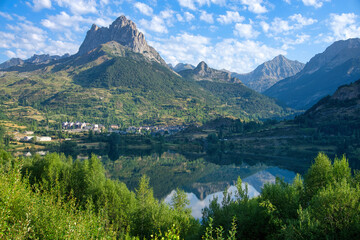 Landscape of a mountain reflected in a lake on a sunny summer morning