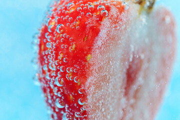 Half of red ripe strawberry with a bubble. Close-up. Macro.