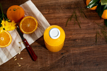 a glass bottle with orange juice top view.