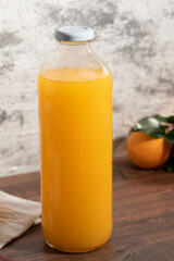 Fototapeta premium close up of a bottle of orange juice with orange fruit.