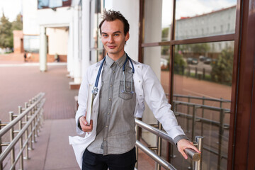 Portrait of a medical student on the threshold of a university clinic. The concept of modern education.