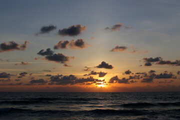 Fototapeta na wymiar The sun sets below the horizon on the Mediterranean Sea in northern Israel.