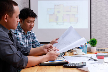 Engineer and Architect concept, Engineer Architects and Interior designer working with blueprints