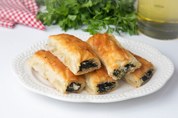 Handmade Spinach Cheese Pie - pastry, Turkish name; el acmasi borek, rulo borek. Turkish borek rolls with spinach and cheese. A traditional Turkish pastry rulo borek