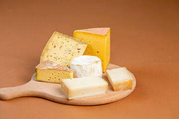 Various cheese types on cutting board