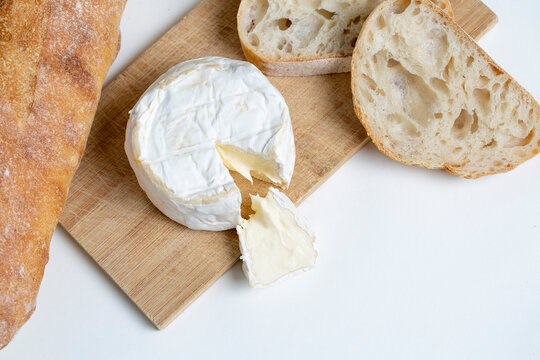 Camembert cheese and bread on cutting board