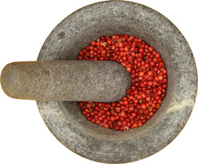 Top view close up on isolated gray basalt stone mortar with pestle and red pepper corns,...