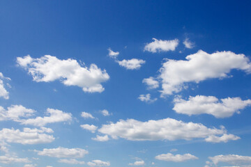 White cumulus clouds in the blue sky.