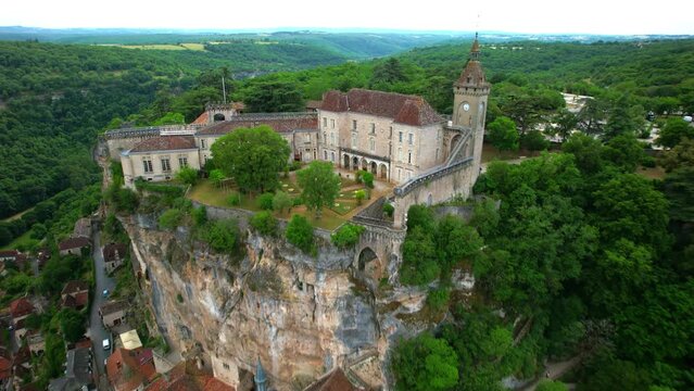 Aerial shot of the famous rocamadour village in France, backward flight from the castle at the top to the general wide landscape view.