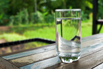 Glass of water outdoors, glass of water and ice on soft background,
