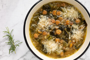 Chicory and chickpea soup with Parmesan (zuppa di ceci e cicoria con parmigiano). Italian cuisine.