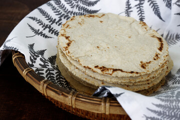 Homemade corn tortillas in a pile. Mexican traditional cuisine bread.