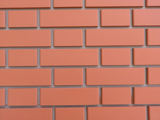 The effect of a red brick wall on concrete close-up