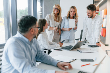 Obraz premium Portrait of senior man. Group of professional business people is in the office