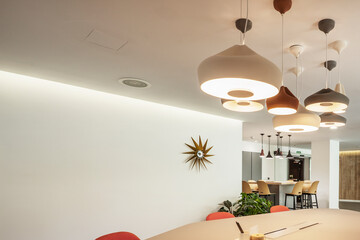 Professional coworking office with many decorative ceiling lamps