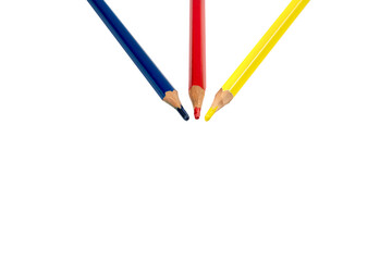 colour pencils 3 primary colours red blue yellow are arranged direction arrow to the center together in studio light. It lay on the white background. Clipping path.