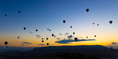 hot air balloons take off at sunrise over the city of goreme