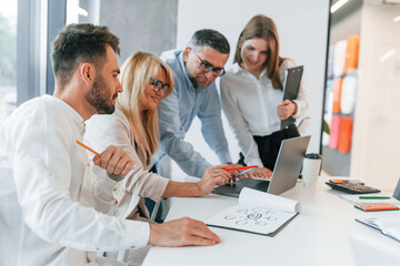 Analizing data. Group of professional business people is in the office